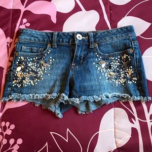 Aeropostale Bejeweled Medium Wash Frayed Booty Shorts. Size 00.